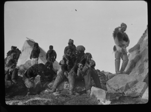 Image of Inuit men, White man holds 2 children